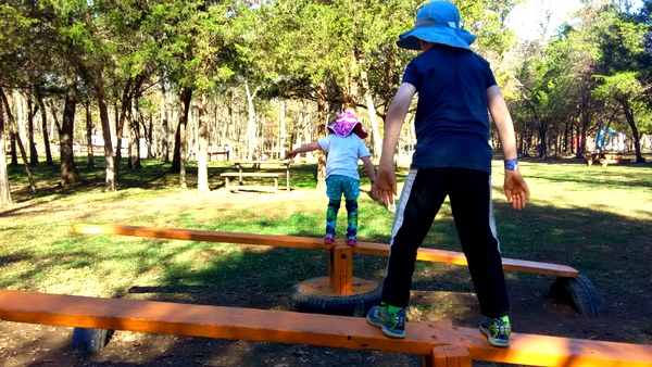 Crunchy-Chewy Mama siblings on teeter totter